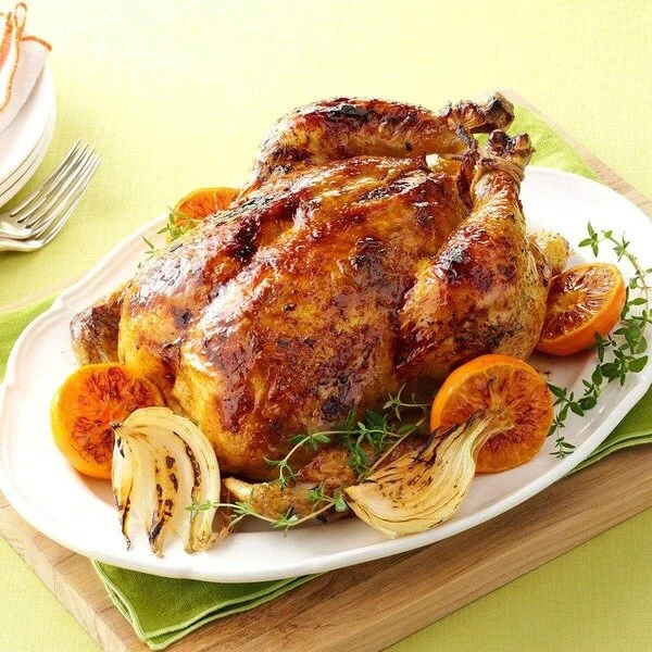 Roasted chicken and citrus fruit on serving dish